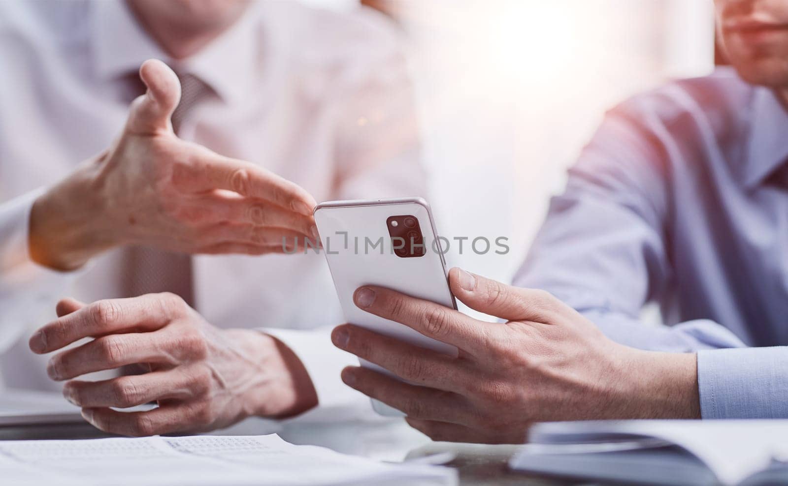 managers read text message on mobile phone in office.
