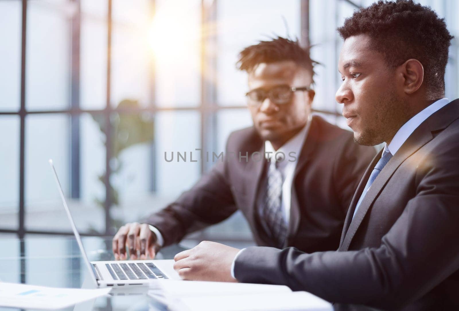 African american boss negotiating discussing contract details with company corporate client.