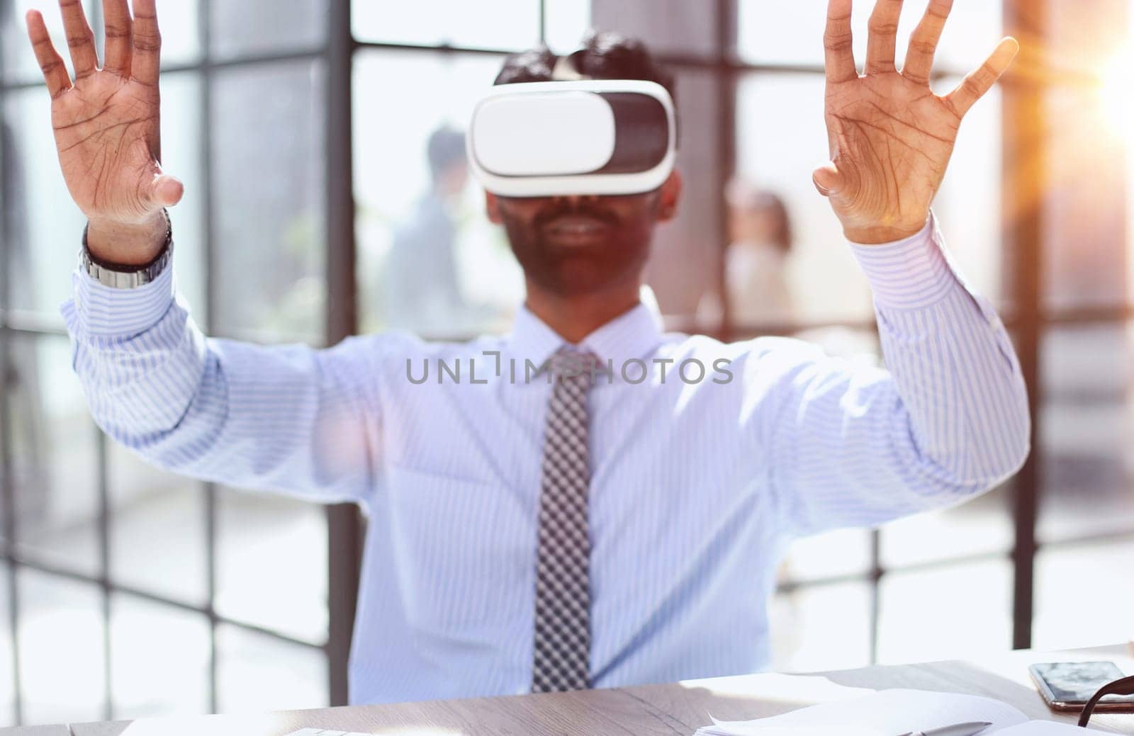 young businessman wearing virtual reality glasses in the office by Prosto
