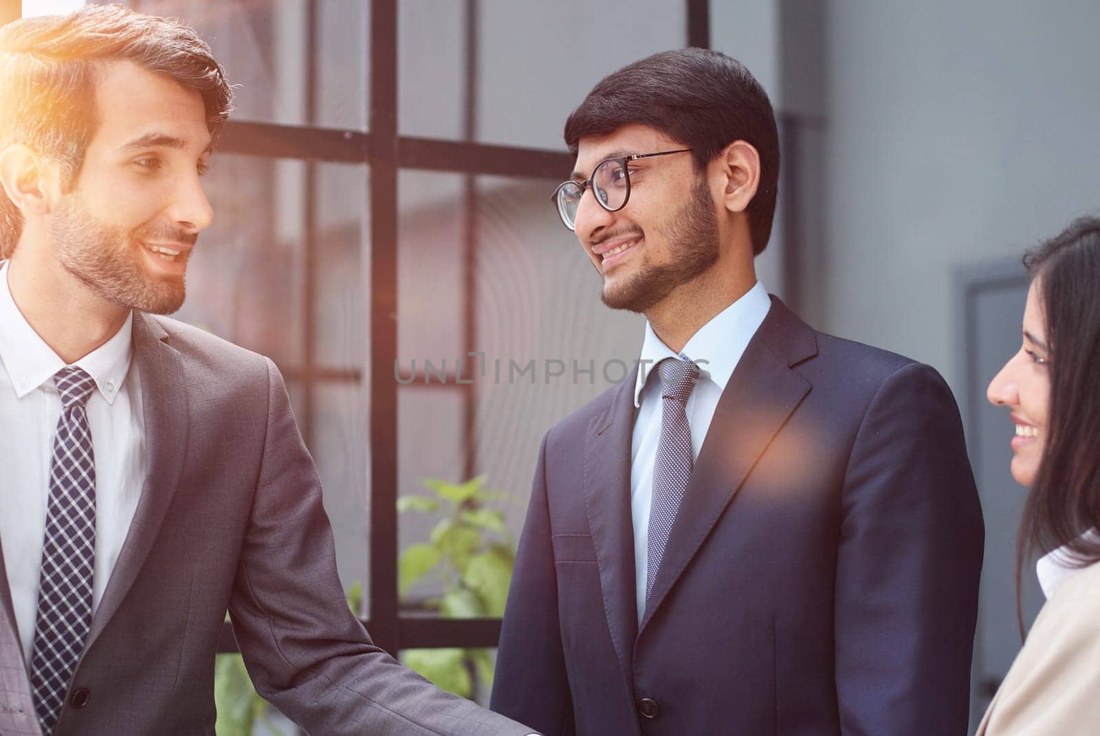 Man shaking hands with woman finishing meeting or signing contract or greeting new employee.