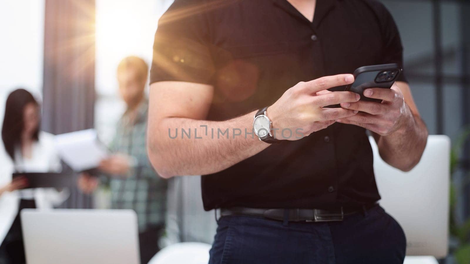 Modern gadget. Close-up of a smartphone screen in the hands of a businessman.