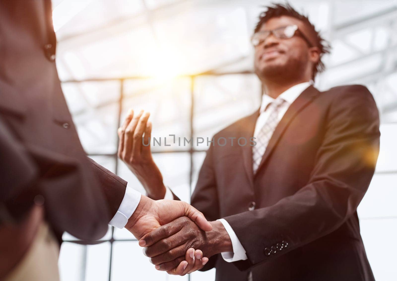 Businessman shaking hands with colleague after meeting in office