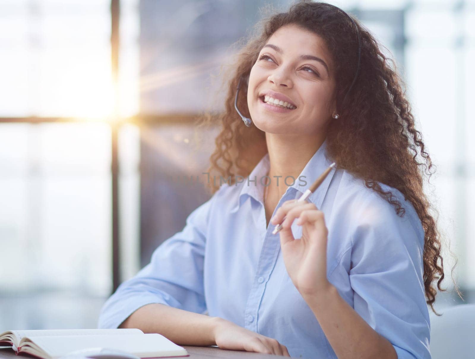 Portrait of an attractive cheerful experienced girl advising clients on customer service in the office