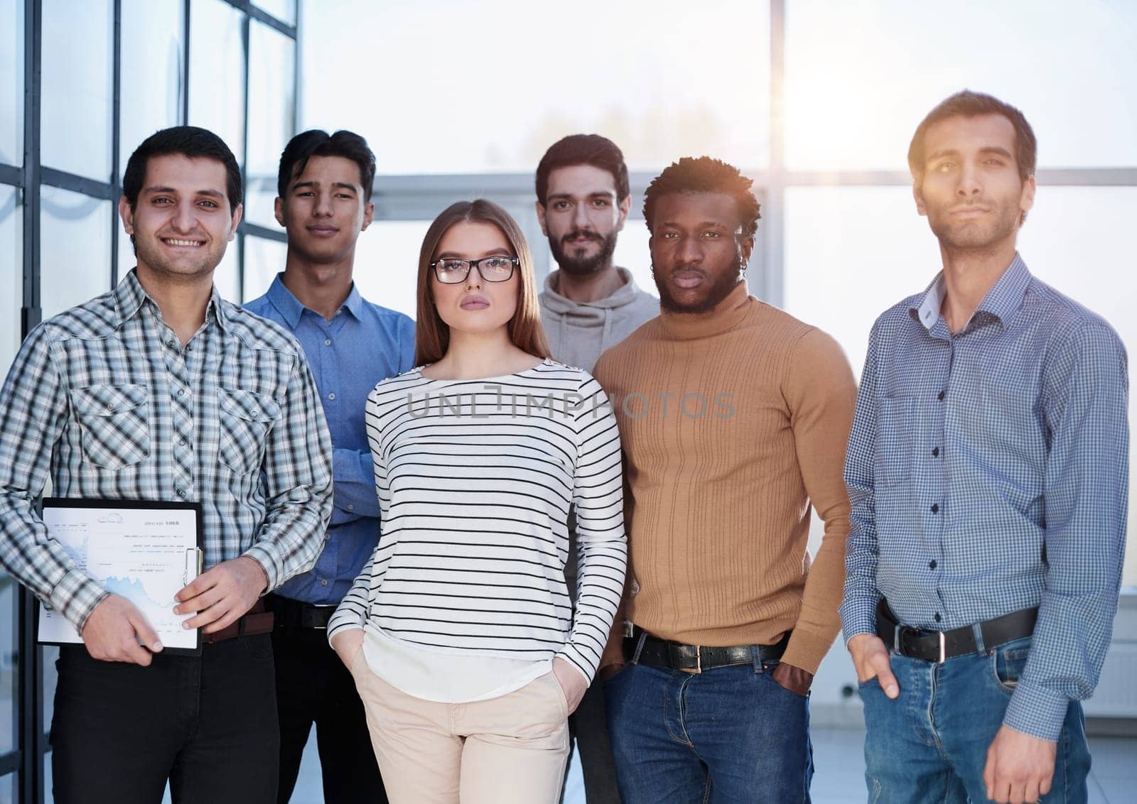 Business people in elegant casual clothes are standing in the office