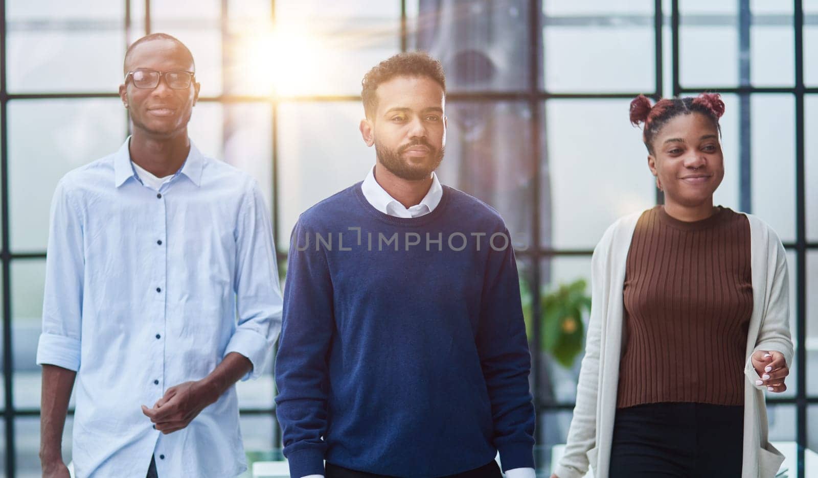 Successful african american business team standing with arms crossed in the office by Prosto