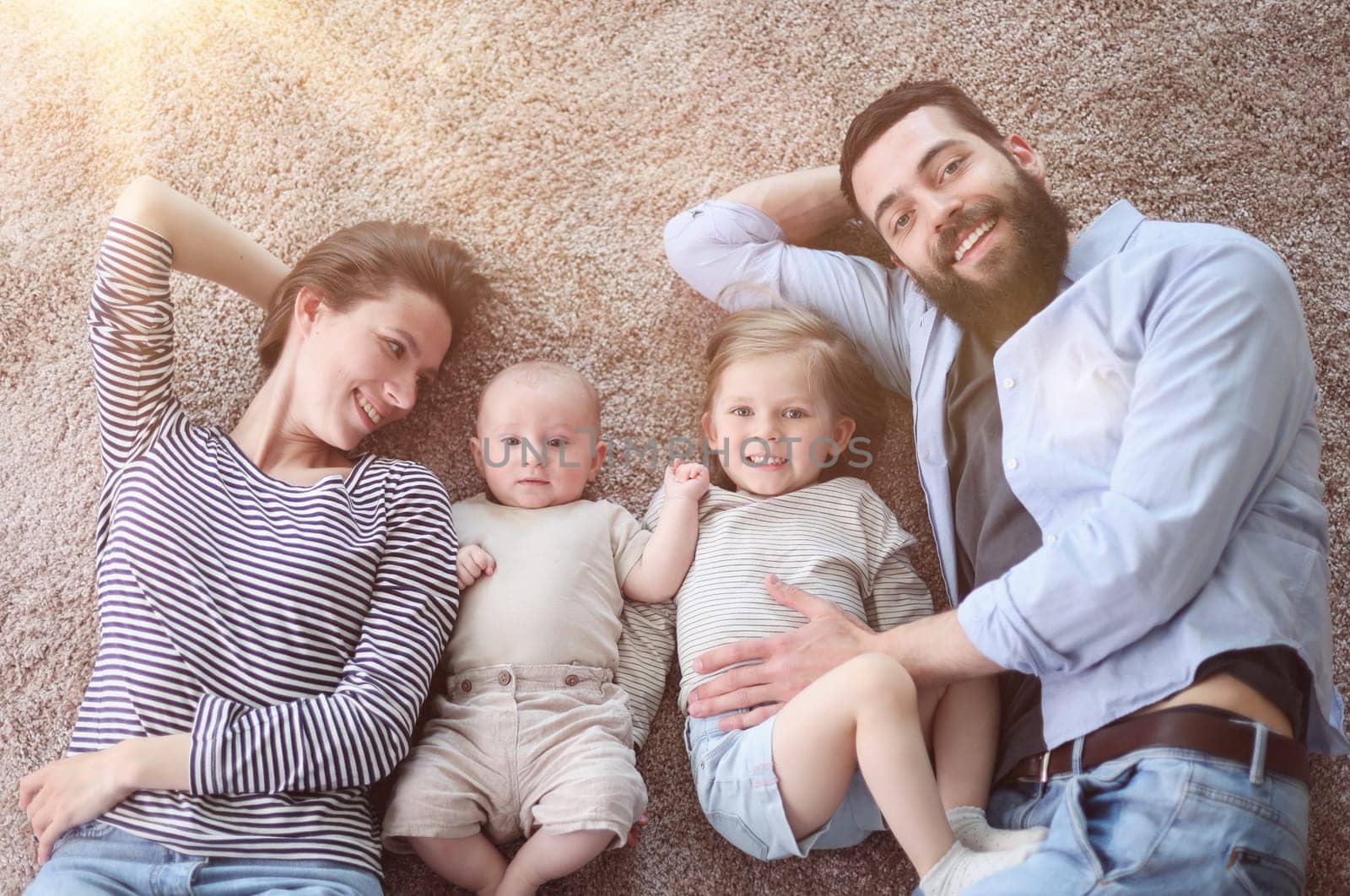 happy family mother father and kids at home. laying