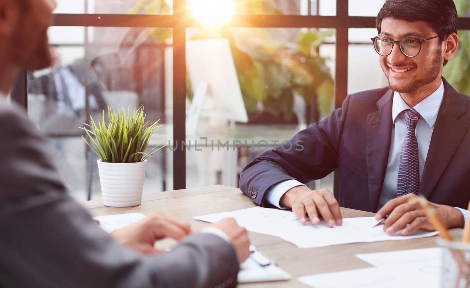 Business people working at desk by windows