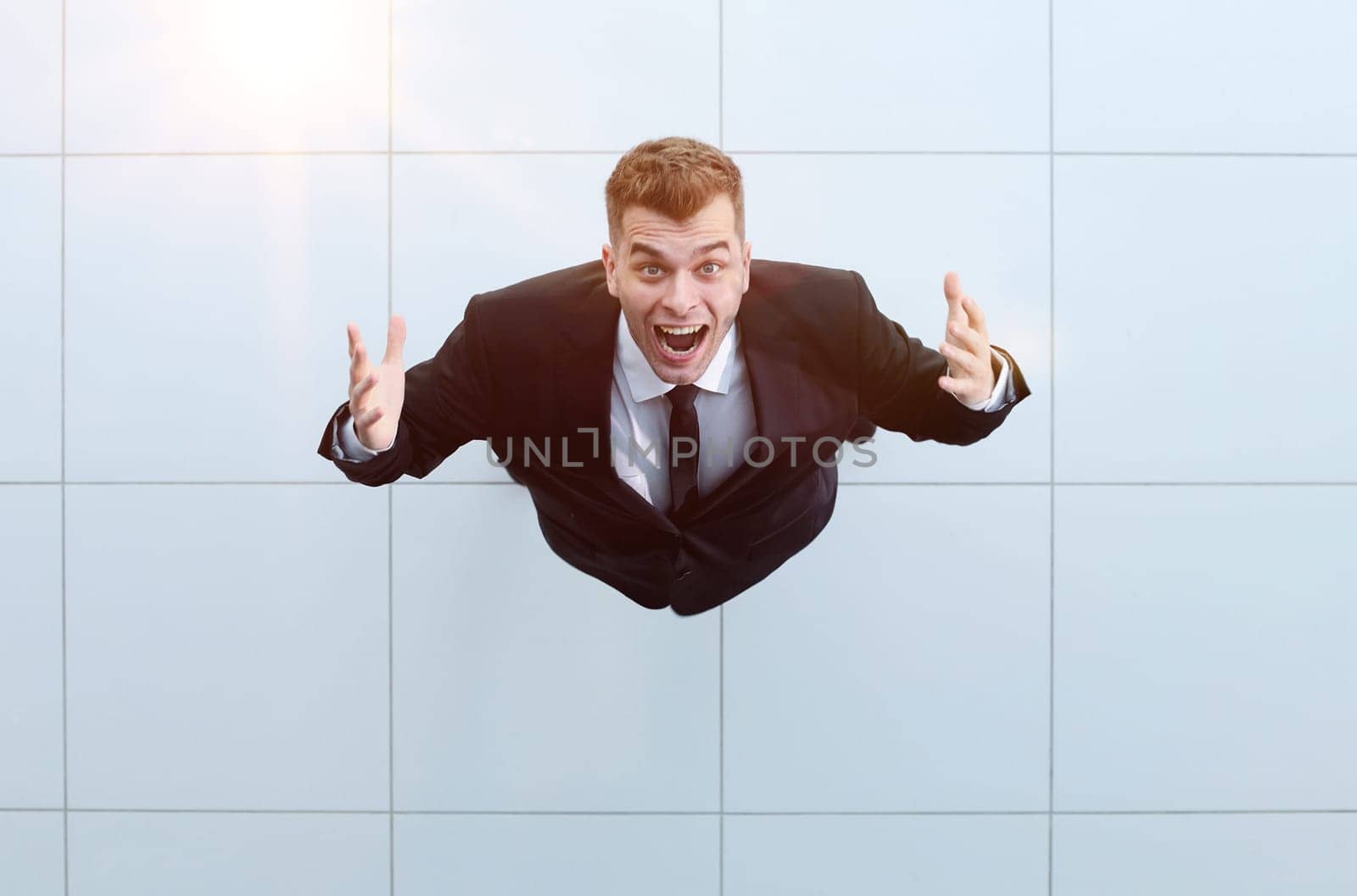 businessman with arms up celebrating his victory