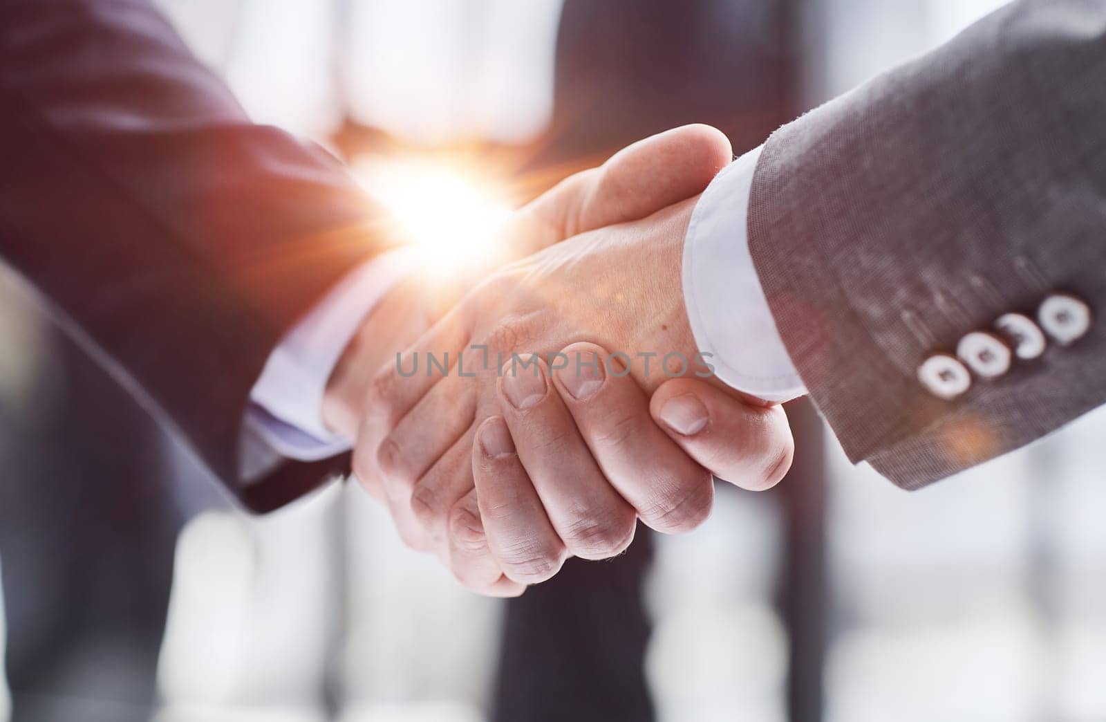 Extreme Closeup of Two Men Shaking Hands by Prosto