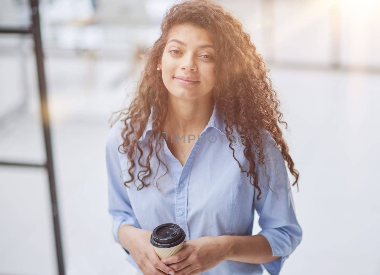 Thoughtful woman thinking while holding a mug of coffee in her hands