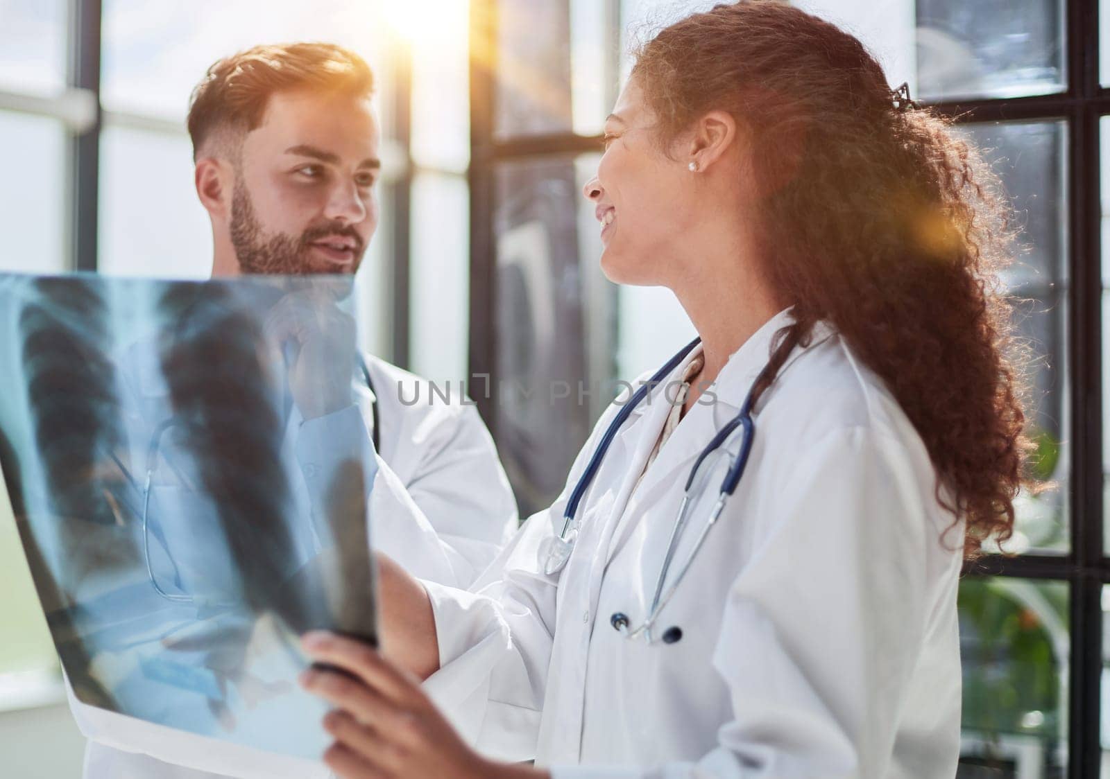 Concentrated male doctor looking at x-ray picture of spine