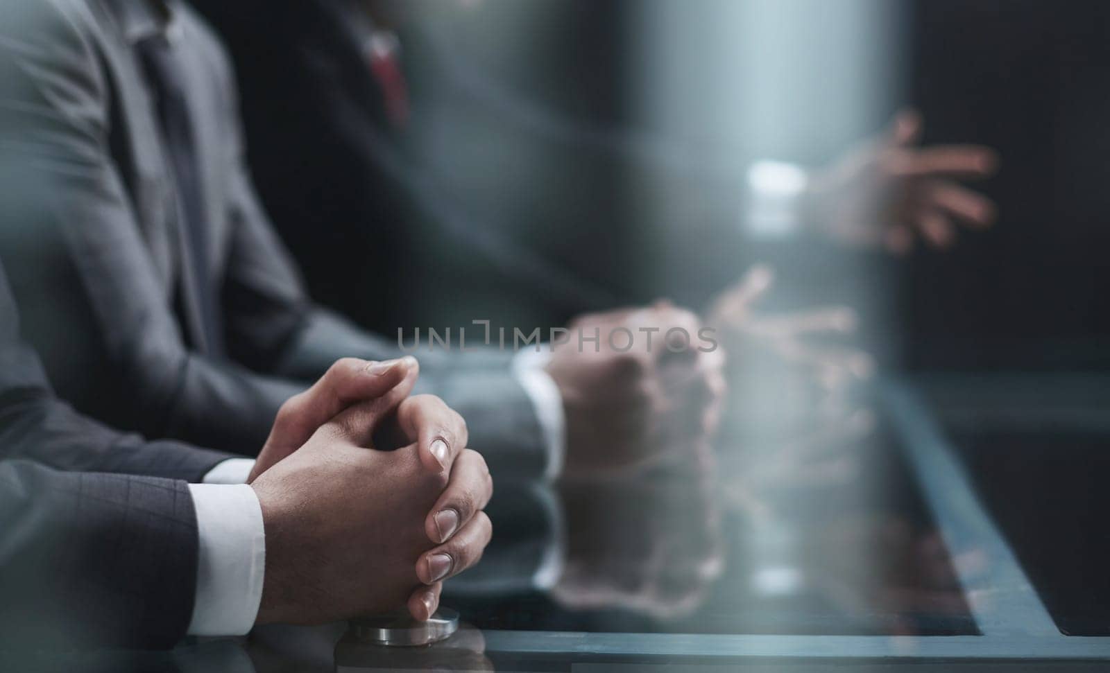 Cropped shot of unrecognizable people, male hands of business people on the table close-up