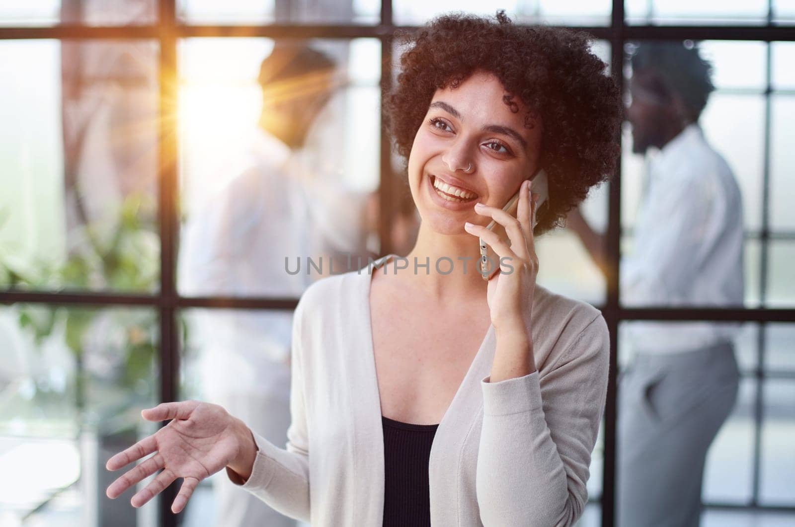 Businesswoman sitting in office, talking on the phone