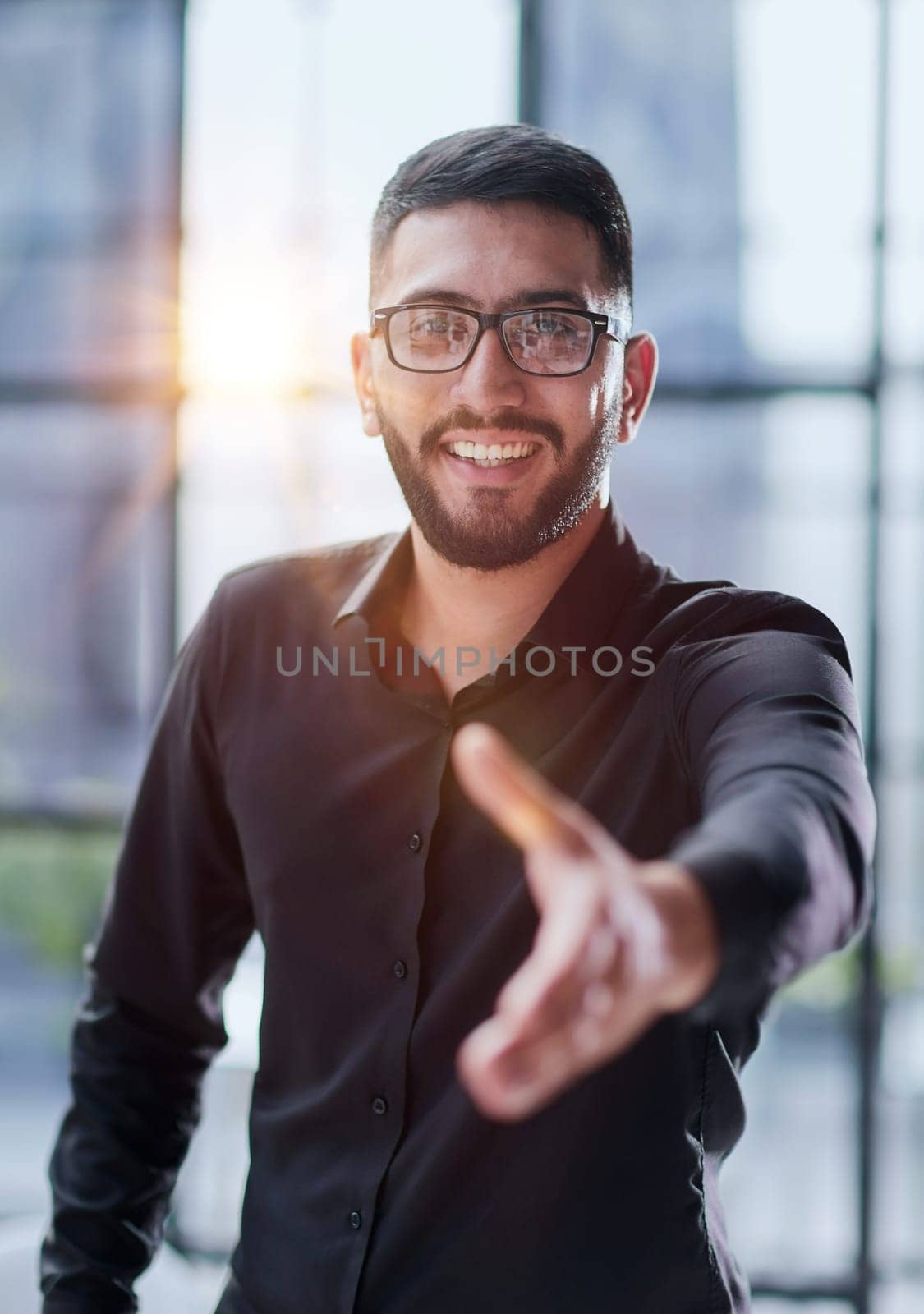 smiling businessman reaching out for a handshake