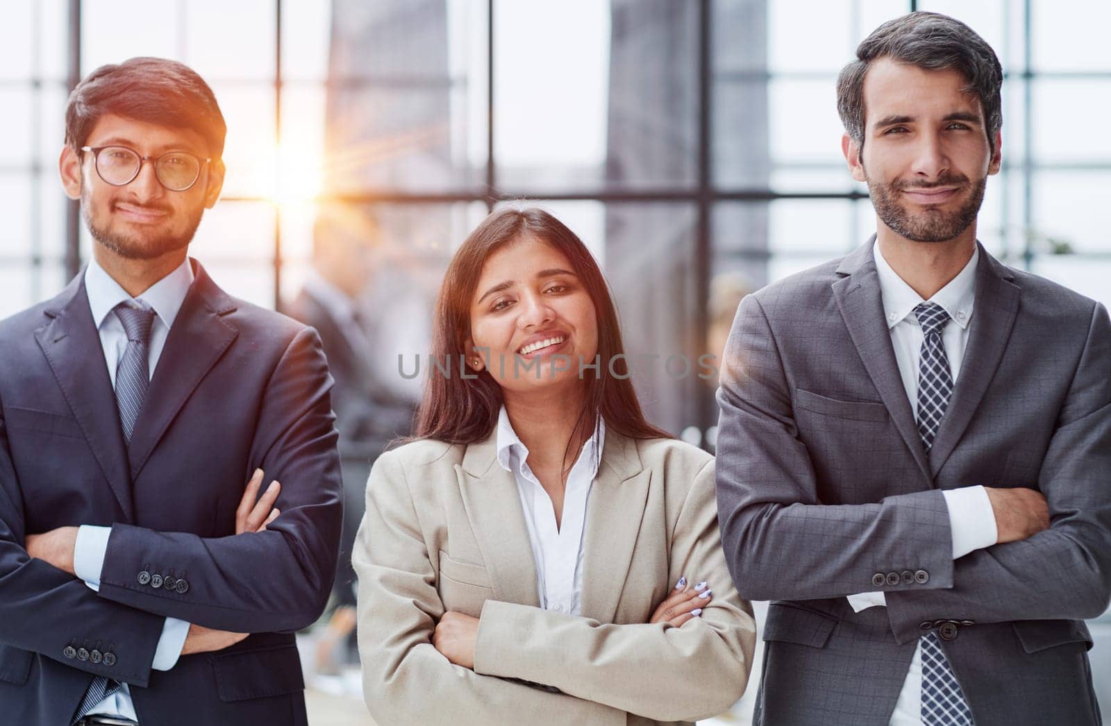 a team of three people stands in a modern office