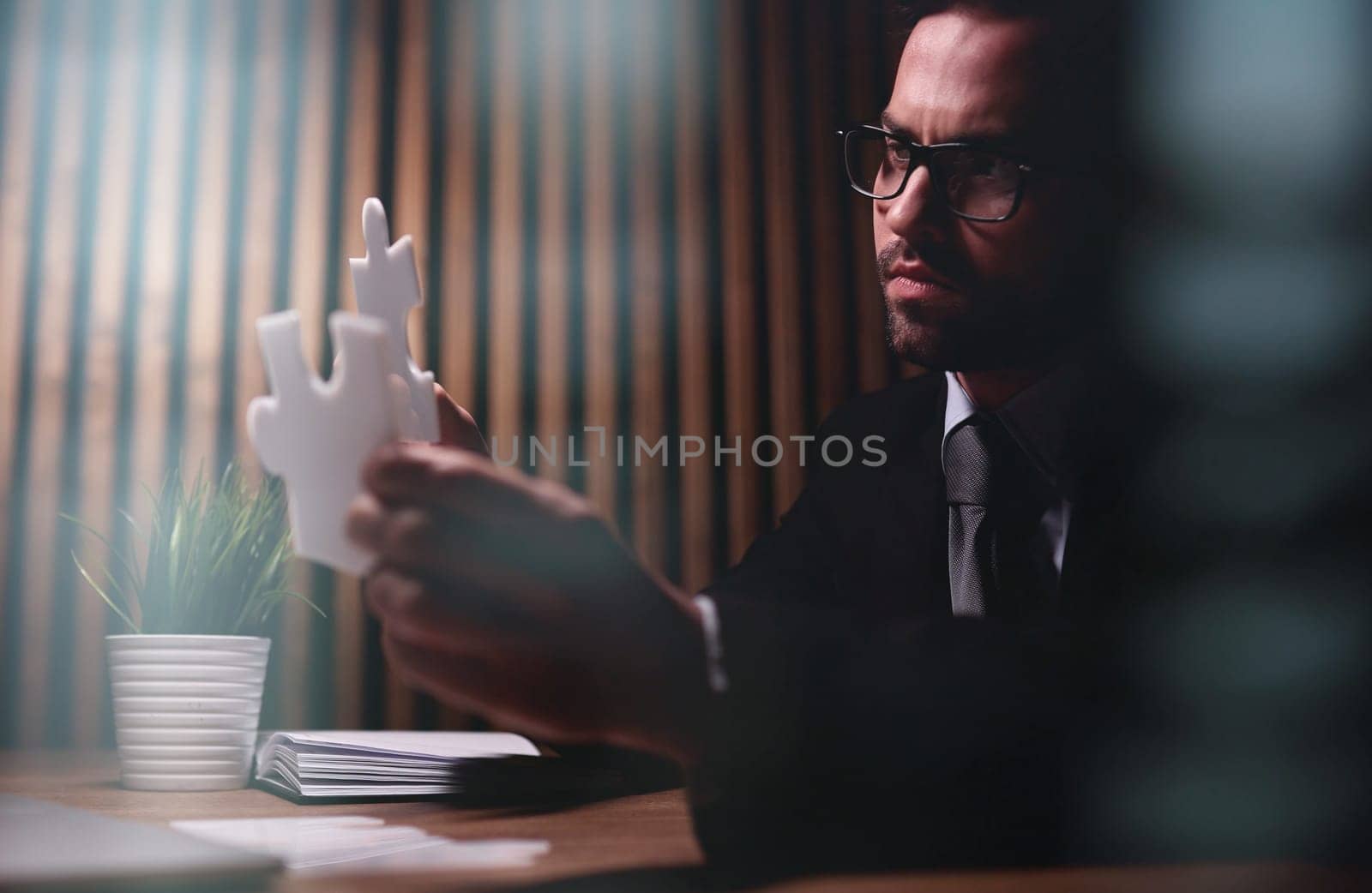 Attractive young guy solves a problem on the table in the office