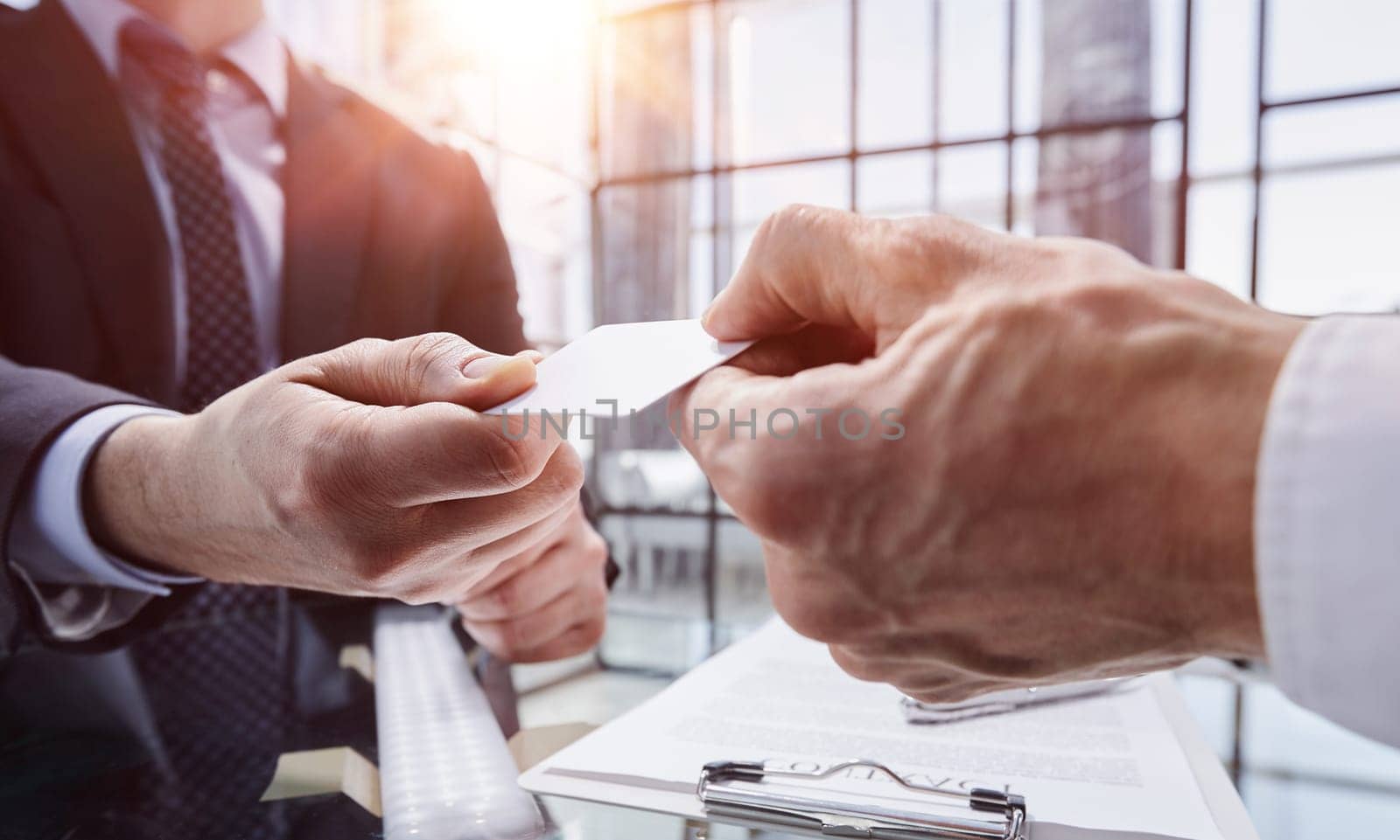 business manager exchanging business card in modern office, close-up