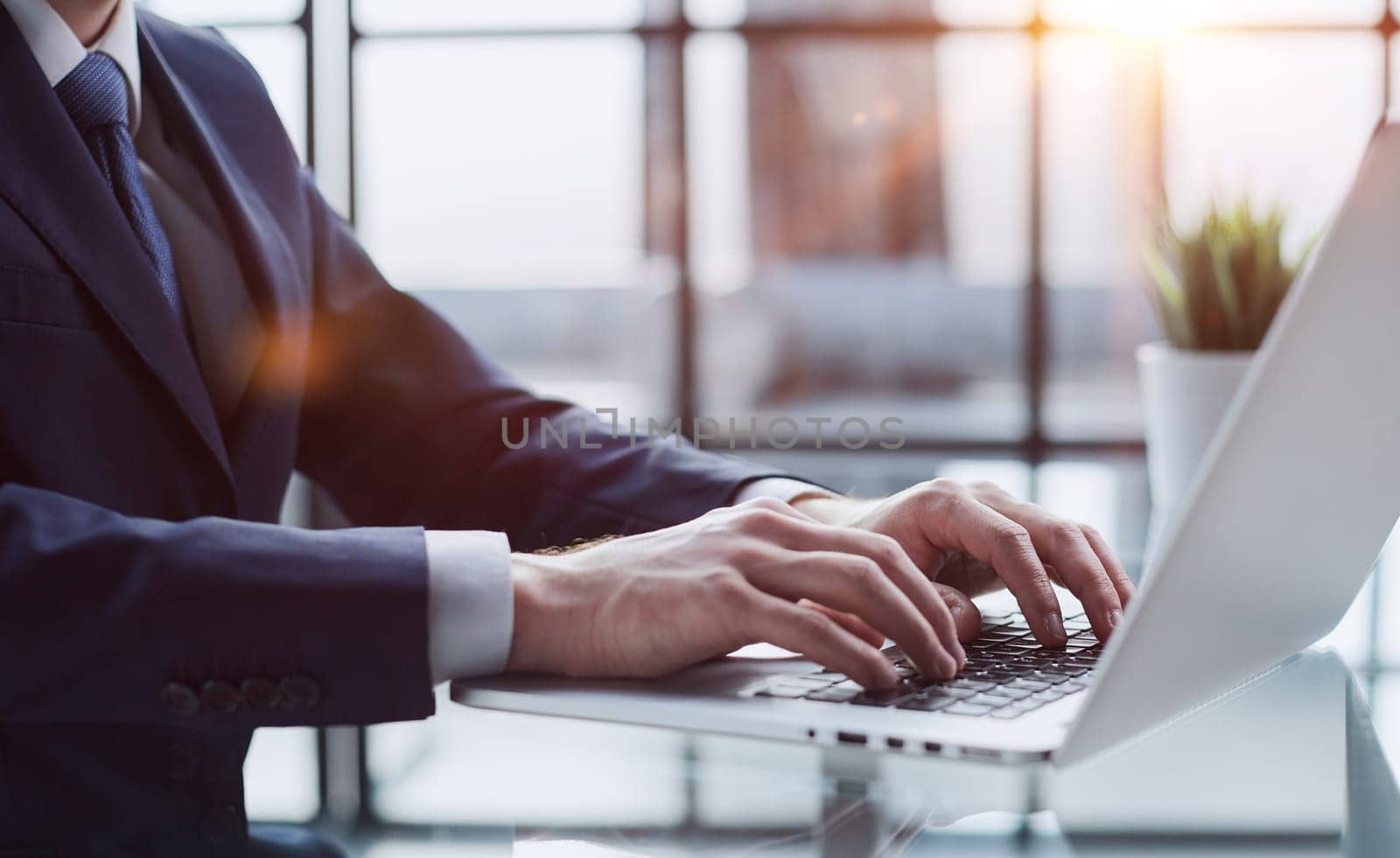 Young man working on computer at table in office, closeup. Banner design