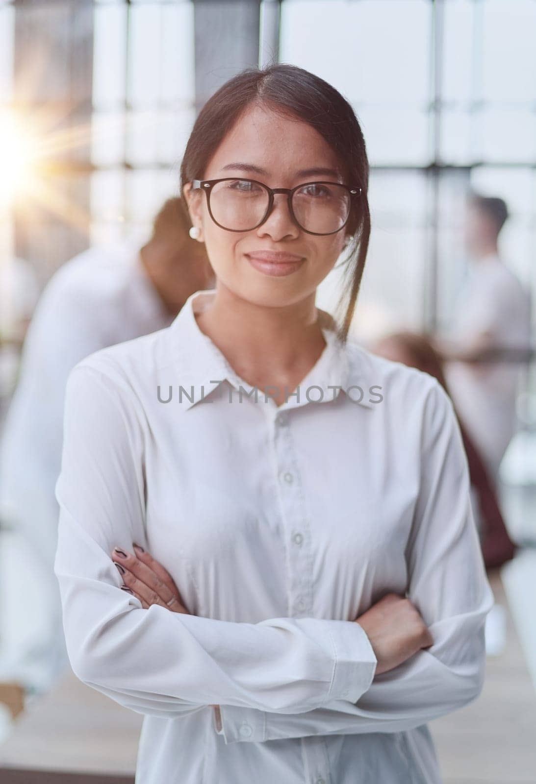 Young beautiful Asian business woman consultant , portrait of an employee looking at the camera by Prosto
