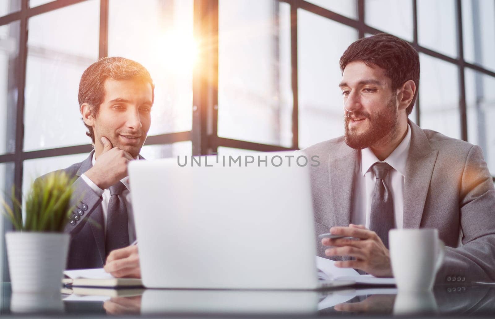 Young business people working in a bright office, at the table by Prosto
