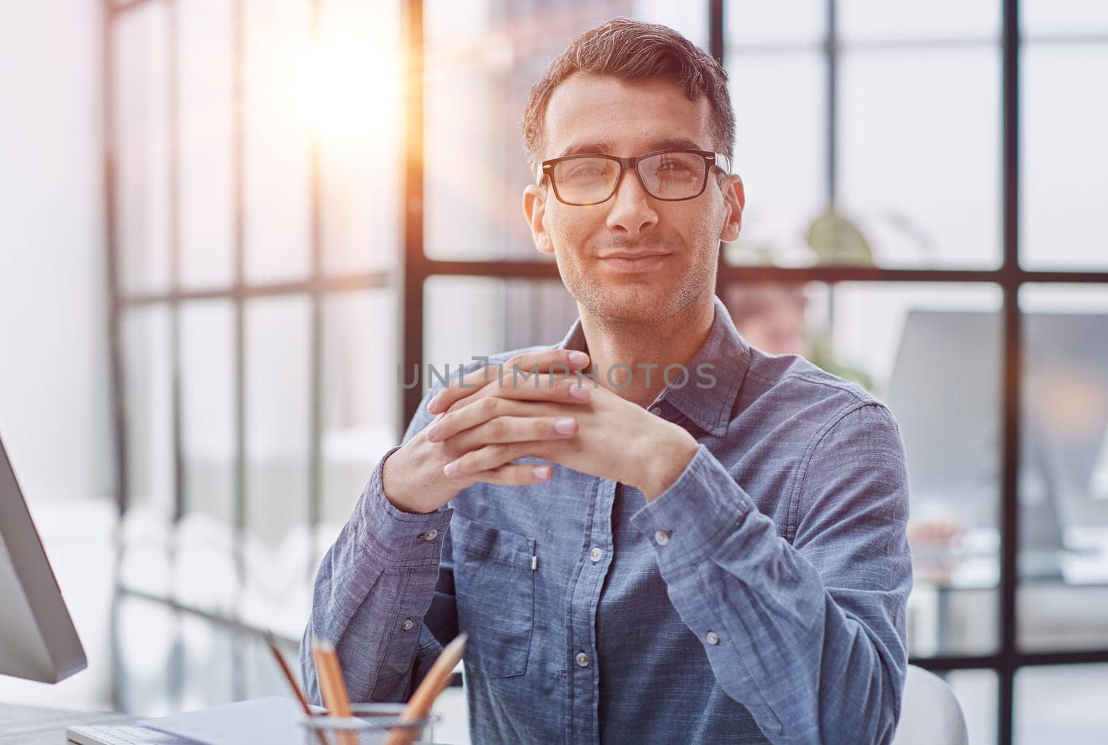 Young caucasian handsome man stretching hand at camera in greeting gesture. by Prosto