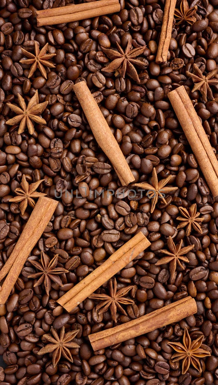 Roasted coffee beans, cinnamon sticks and star anise, full frame