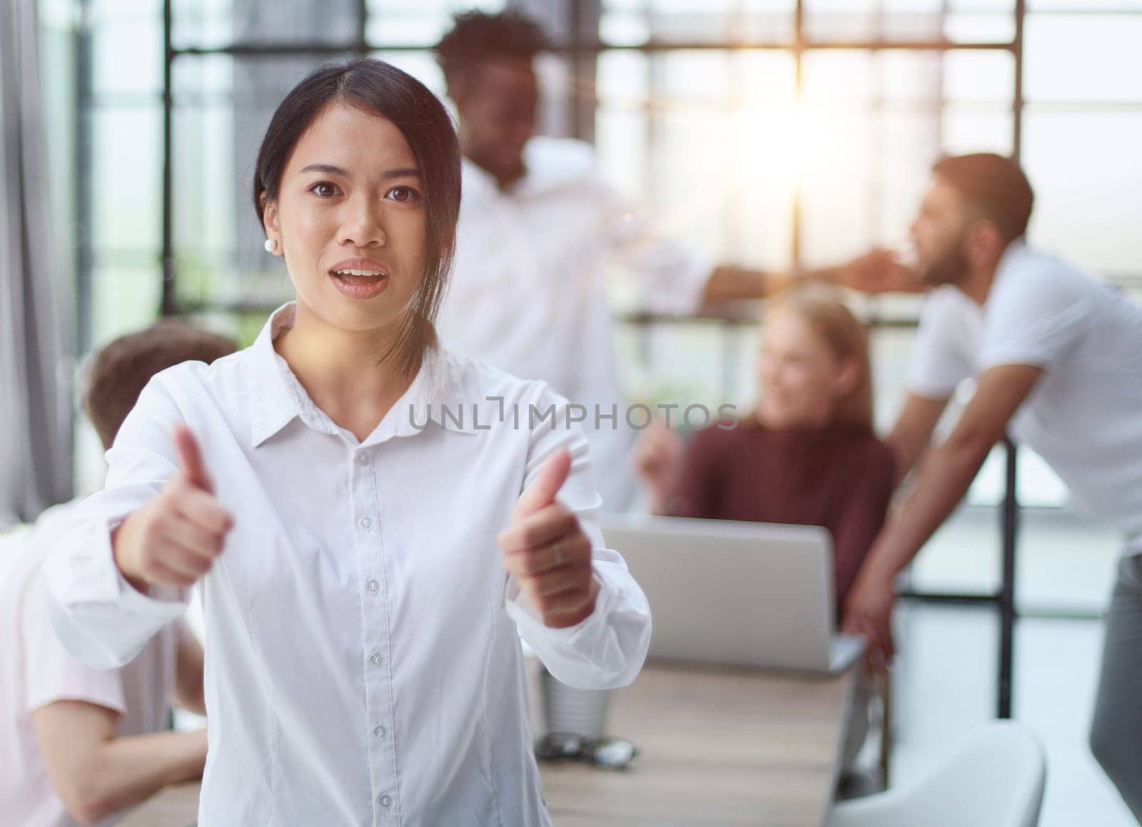 young successful businesswoman in white shirt smiling in the office