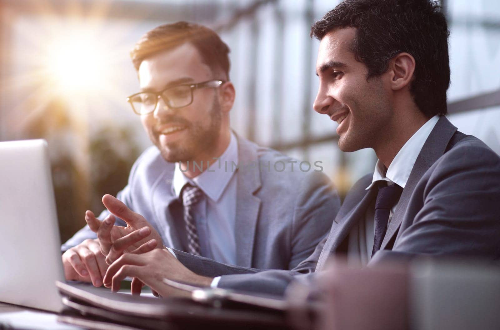 Young business people working in the office with a laptop on the table by Prosto