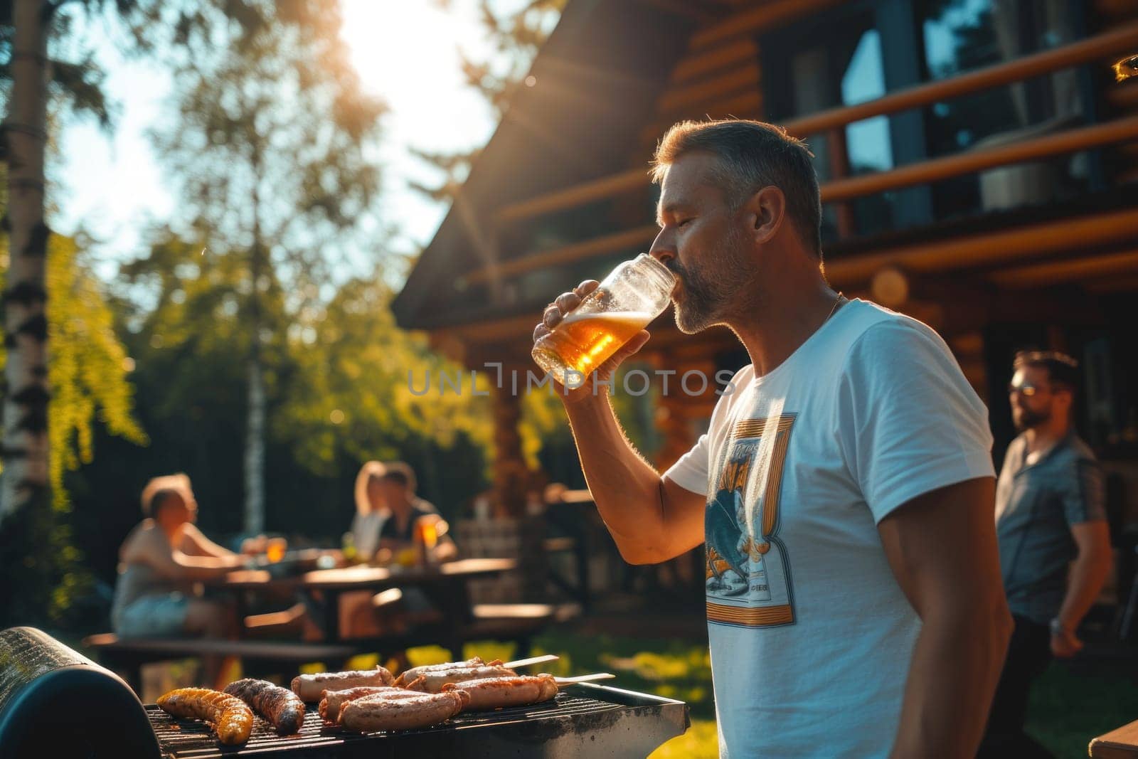 A man in a T-shirt in his forties drinks a beer with friends nearby, sunny day. Generative AI.