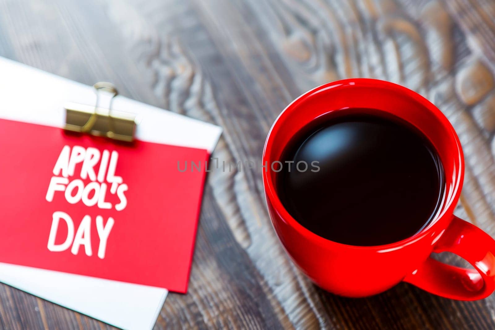April fool's day with coffee red mug background .Ai generative.