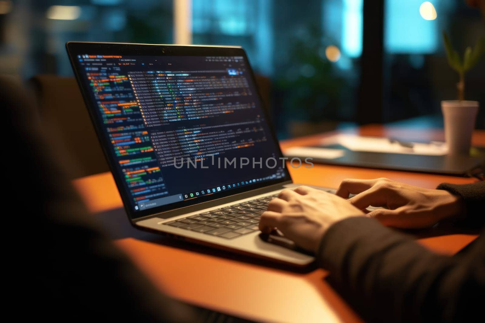 Close up of Computer programmer working on laptop.