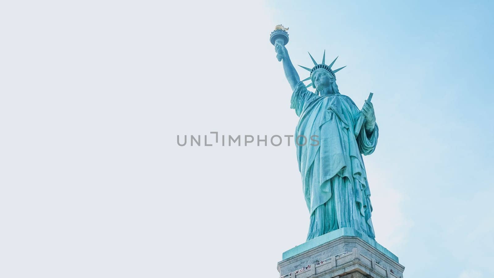 The Statue of Liberty, New York City on sunny blue sky. American symbol. Memorial day, Patriot Day. Space for text. New York NY USA 2023-07-30.