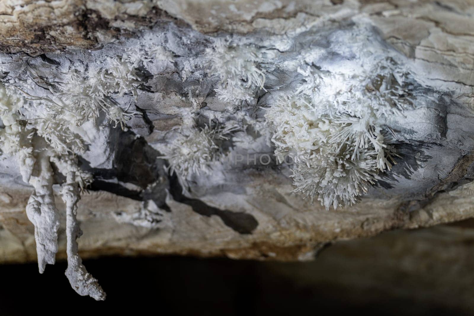 Exploration of a cave's crystalline formations, highlighting the natural art in geology.