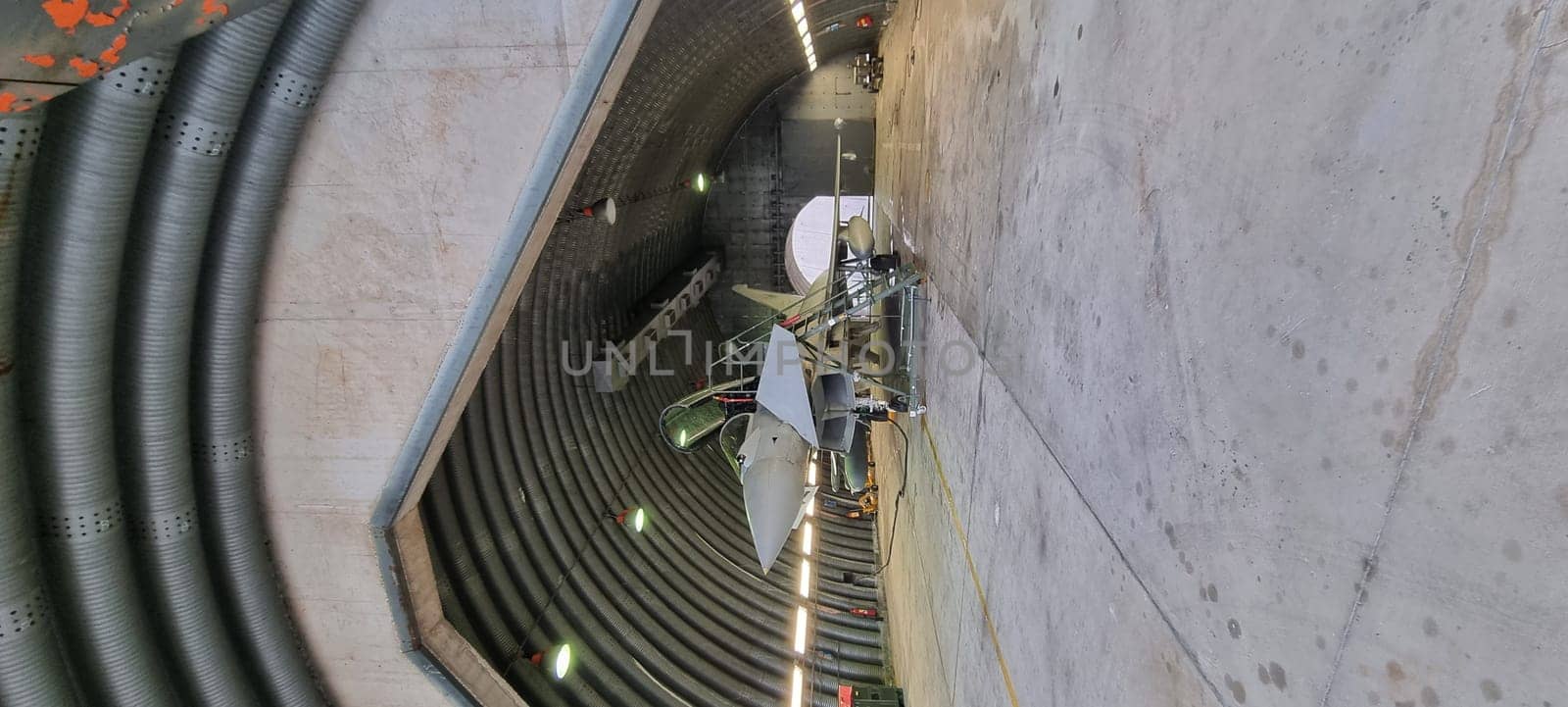 Modern Defense Aircraft in Armored Shelter Ready for Takeoff, Vertical Photo by FlightVideo