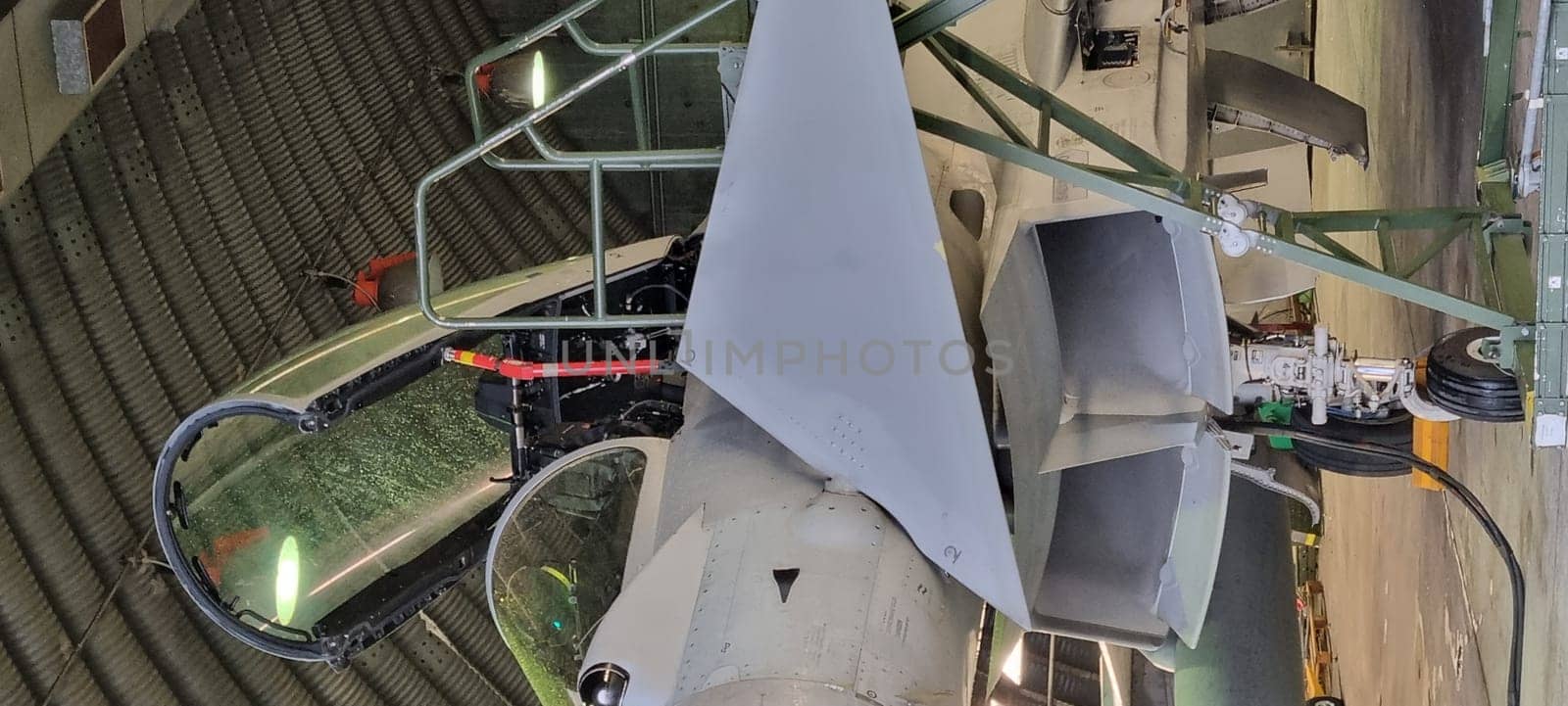Istrana Italy December 13 2023: Close-up of the ladder and cockpit of an interceptor military aircraft parked in an armored shelter, ready for NATO defense alert takeoff. Includes copy space.