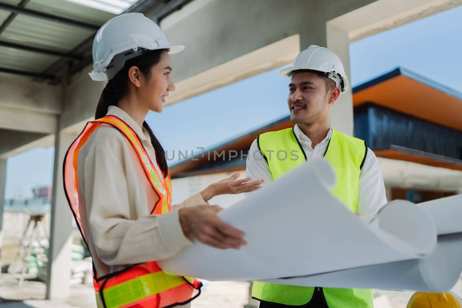 team engineer, foreman, architect meeting for colleagues discussing and checks construction blueprints at onsite.