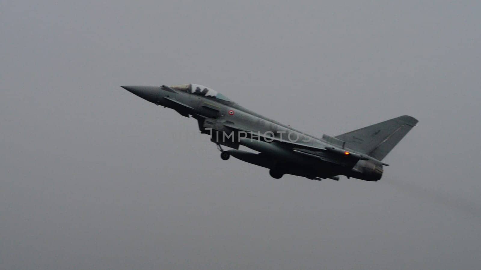 Istrana Italy December 13 2023: Showcasing resilience, a NATO supersonic defense aircraft patrols the grey skies on a day of bad weather, affirming airspace security regardless of conditions.