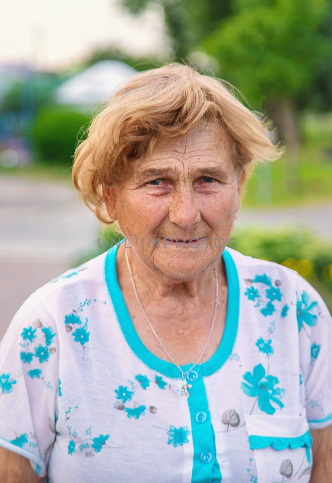 Old woman in the garden. Selective focus. Nature.