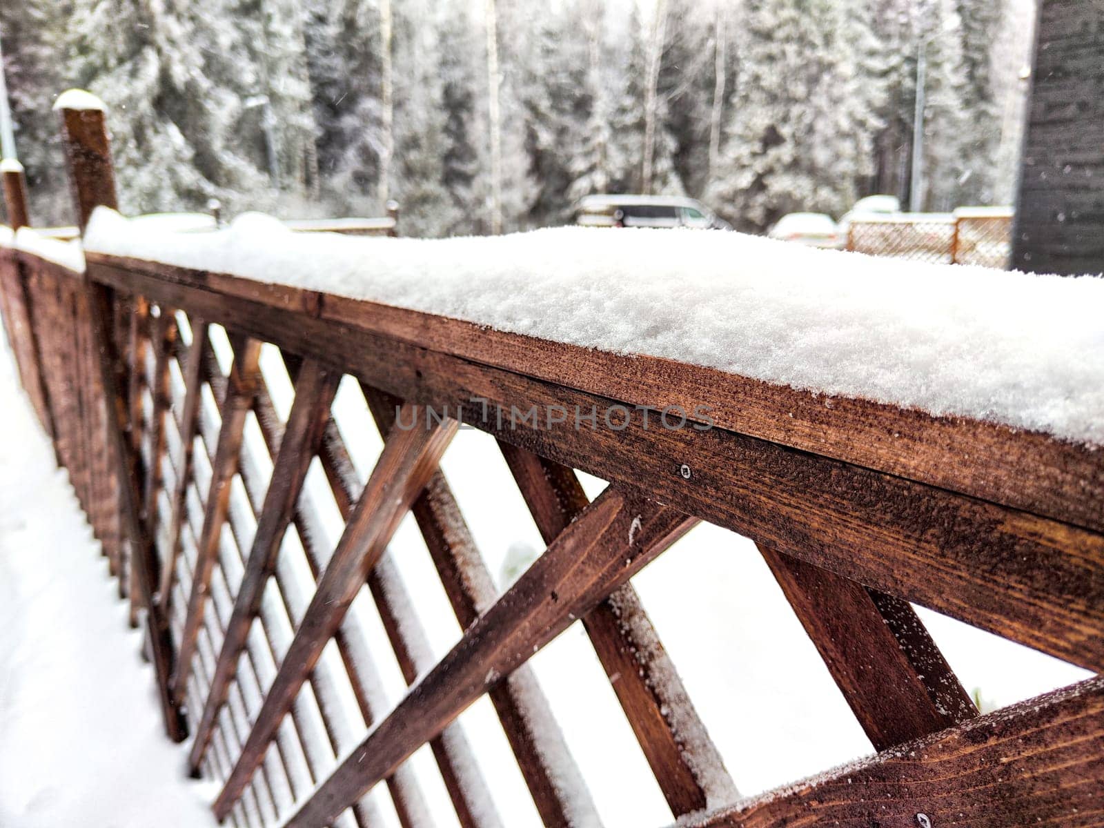 Wooden grate or fence is covered with frost. Frosty freshness on the street in the village. Background, pattern, frame