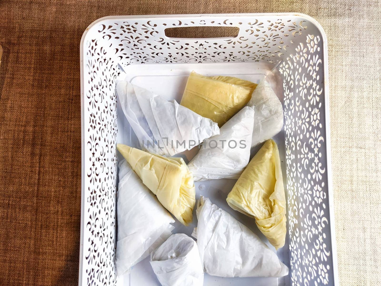 Plastic bag folded into triangle for storage. Ways of storing and laying at home