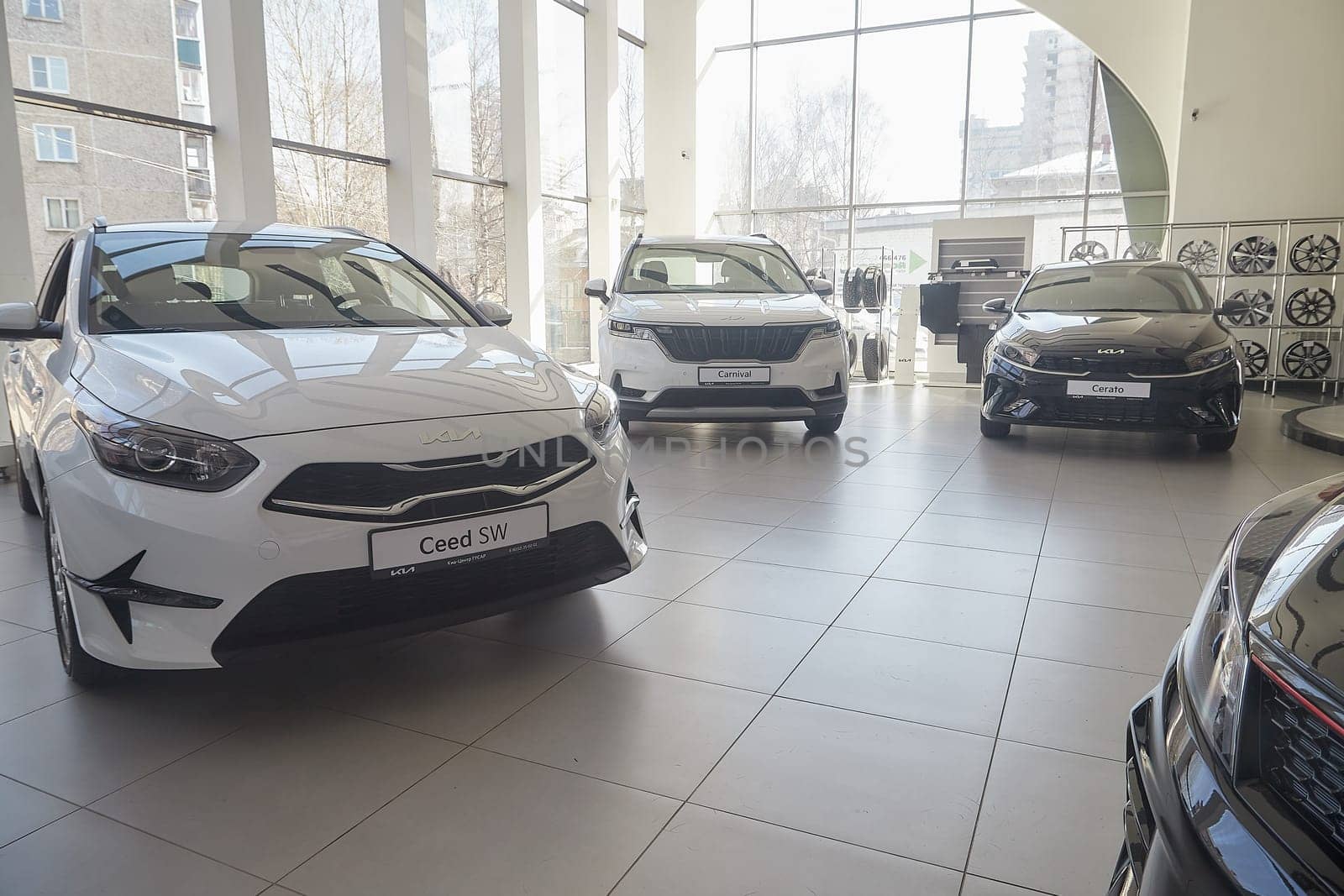 Kirov, Russia - April 12, 2022: Cars in showroom of dealership Kia in Kazan in Russia. Partial focus