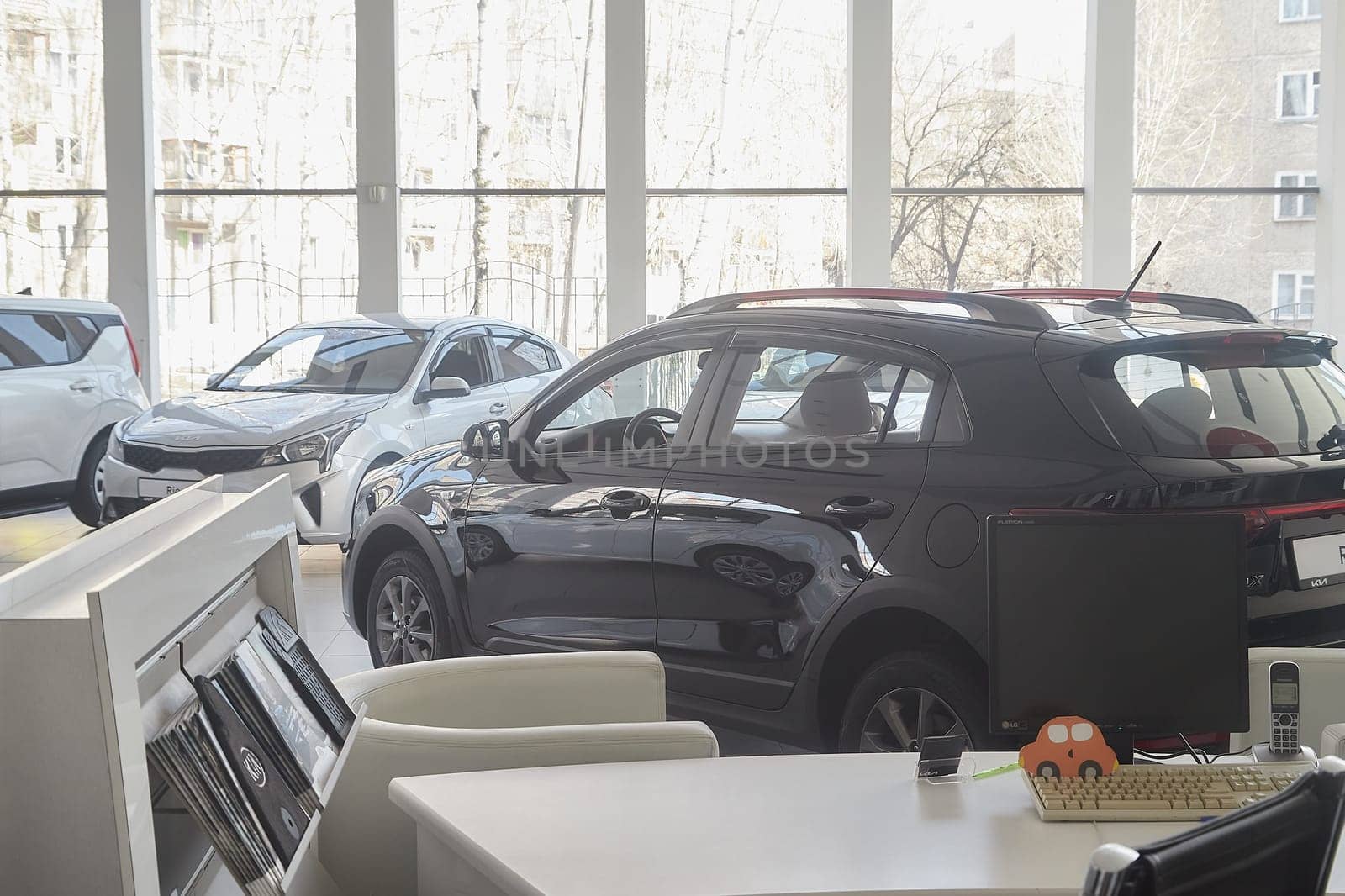 Kirov, Russia - April 12, 2022: Cars in showroom of dealership Kia in Kazan in Russia. Partial focus