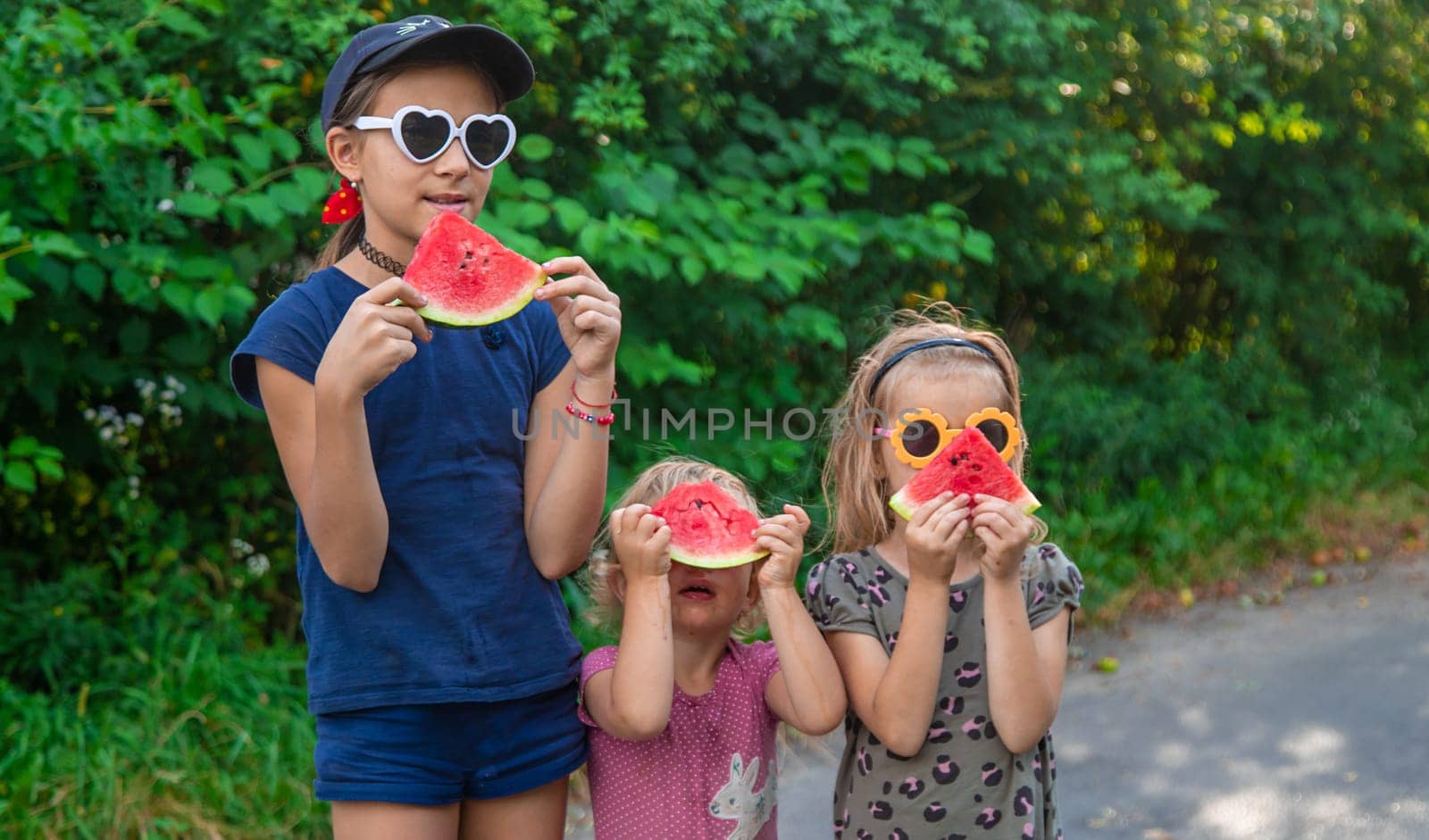 Children in the park eat watermelon. Selective focus. Food.