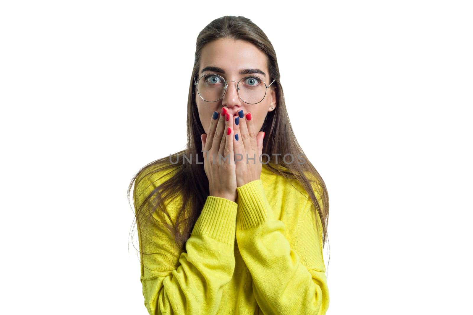Young surprised woman in glasses yellow clothes on white isolated background, female amazed looking at the camera covered her mouth with her hands