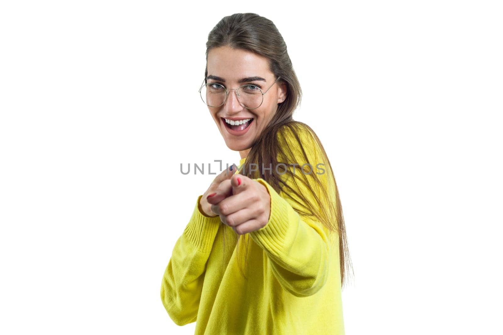 Young charming woman in glasses yellow clothes on white isolated background, surprised emotional female pointing finger at you