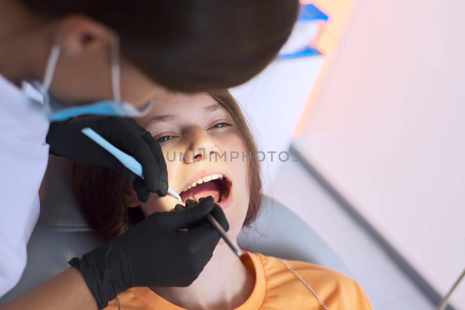 Close up dental treatment procedure in dental office by VH-studio