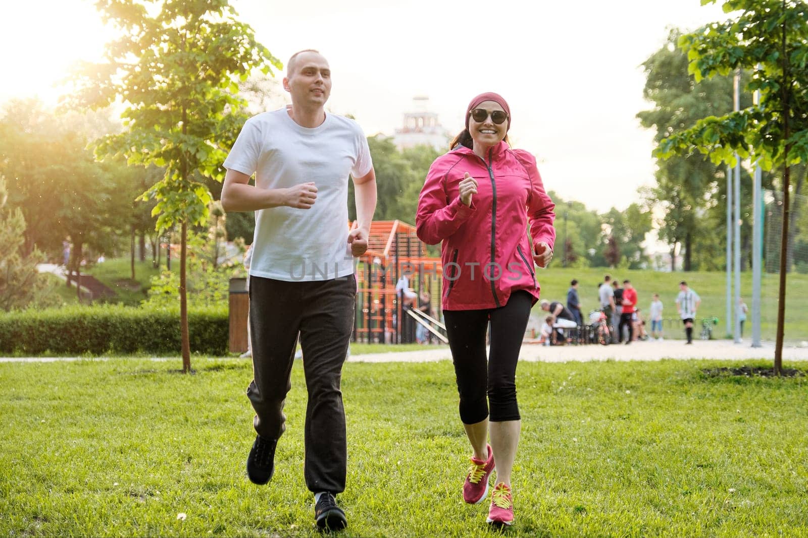 Running smiling mature couple outdoor, sport active lifestyle by VH-studio