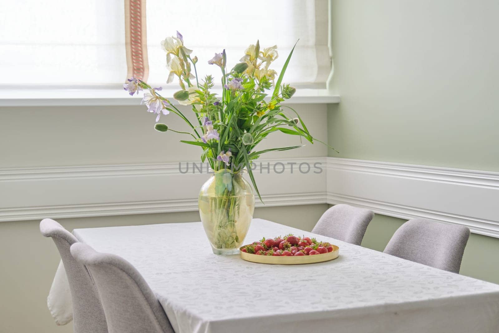 Home dining room interior, spring summer bouquet of flowers, strawberries by VH-studio