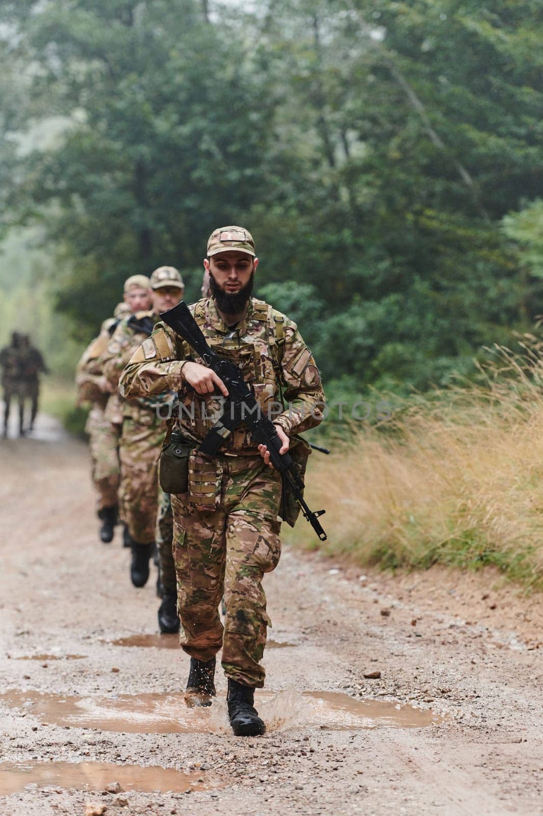 A disciplined and specialized military unit, donned in camouflage, strategically patrolling and maintaining control in a high-stakes environment, showcasing their precision, unity, and readiness for special operations.