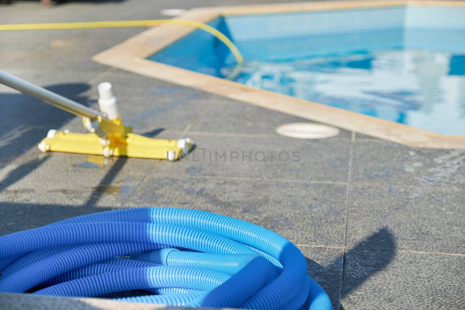 Water vacuum cleaner for cleaning the pool. Details of cleaner near an outdoor pool, nobody